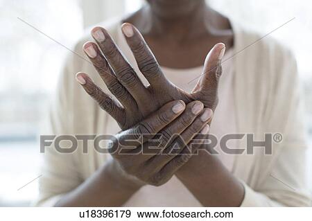 Stock Photo - Woman with hand pain. Fotosearch