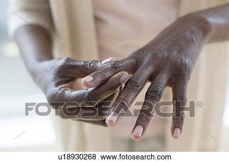 Stock Photo - Woman with hand pain. Fotosearch