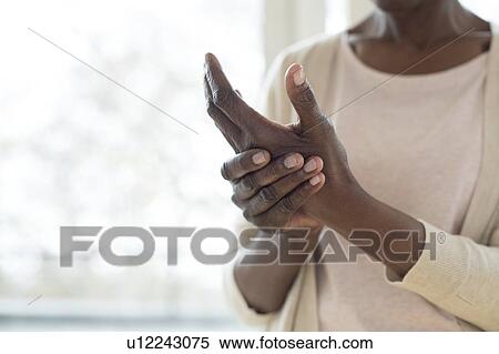 Stock Photography - Woman with hand pain. Fotosearch
