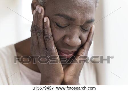 Stock Photo - Woman with head in hands. Fotosearch