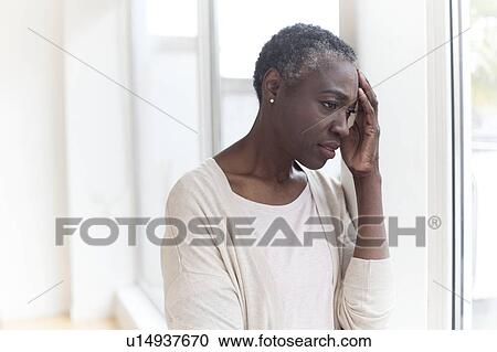 Stock Image - Woman with headache. Fotosearch