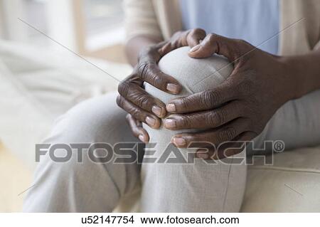Picture - Woman with knee pain. Fotosearch
