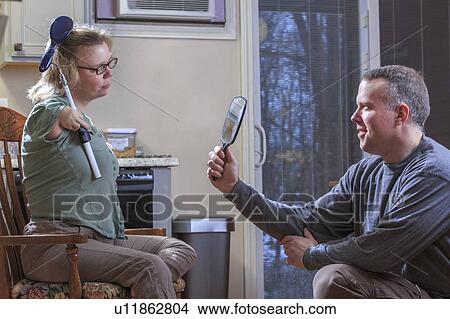 Picture - Woman with TAR Syndrome brushing her hair. Fotosearch