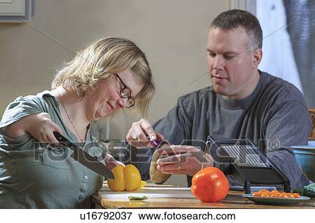 Woman with TAR Syndrome cutting vegetables View Large Photo Image Stock Photo - Woman with TAR Syndrome cutting vegetables. Fotosearch