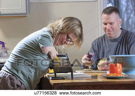 Woman with TAR Syndrome grating vegetables View Large Photo Image Stock Photo - Woman with TAR Syndrome grating vegetables. Fotosearch