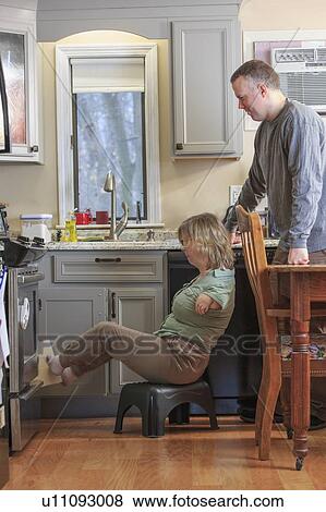 Stock Photo - Woman with TAR Syndrome in kitchen. Fotosearch