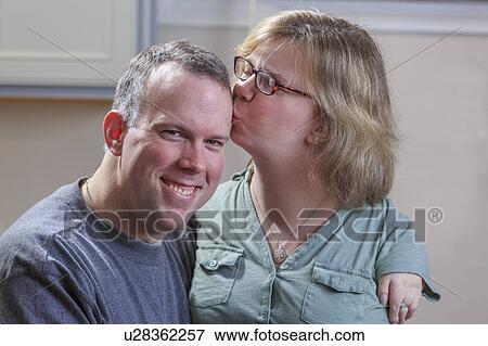 Woman with TAR Syndrome kissing her husband View Large Photo Image Stock Photo - Woman with TAR Syndrome kissing her husband. Fotosearch