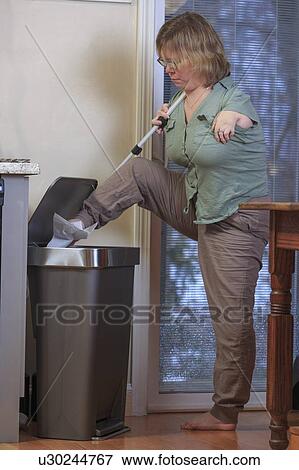 Woman with TAR Syndrome throwing away rubbish View Large Photo Image Stock Photo - Woman with TAR Syndrome throwing away rubbish. Fotosearch