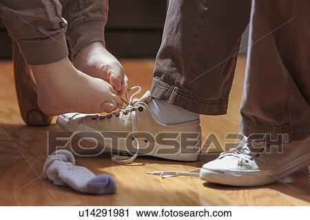 Woman with TAR Syndrome tying shoelaces with her feet View Large Photo Image Stock Image - Woman with TAR Syndrome tying shoelaces with her feet. Fotosearch