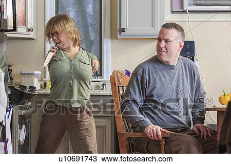 Stock Image - Woman with TAR Syndrome using kitchen knife. Fotosearch