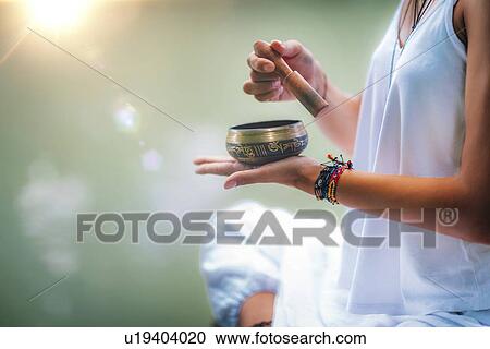 Woman with Tibetan singing bowl View Large Photo Image Stock Image - Woman with Tibetan singing bowl. Fotosearch