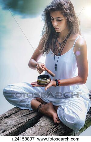 Woman with Tibetan singing bowl View Large Photo Image Stock Photo - Woman with Tibetan singing bowl. Fotosearch