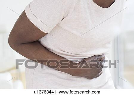 Woman with tummy ache View Large Photo Image Stock Image - Woman with tummy ache. Fotosearch