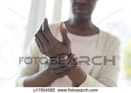 Stock Image - Woman with wrist pain. Fotosearch