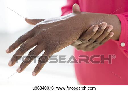 Stock Image - Woman with wrist pain. Fotosearch
