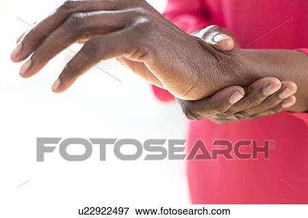 Stock Photo - Woman with wrist pain. Fotosearch