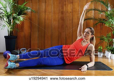 Stock Image - Woman working out. Fotosearch