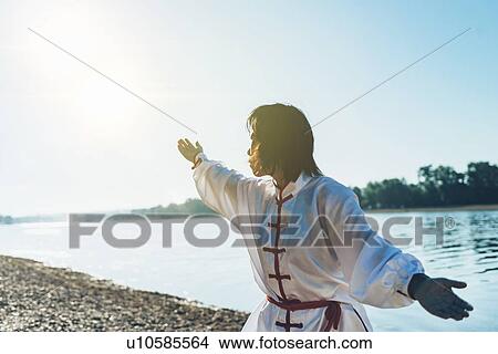 Women practicing tai chi by lake View Large Photo Image Picture - Women practicing tai chi by lake. Fotosearch
