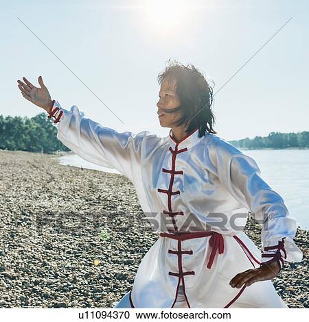 Women practicing tai chi by lake View Large Photo Image Stock Image - Women practicing tai chi by lake. Fotosearch