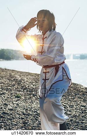 Women practicing tai chi by lake View Large Photo Image Stock Image - Women practicing tai chi by lake. Fotosearch