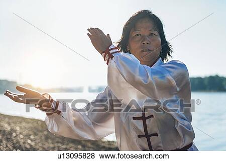Women practicing tai chi by lake View Large Photo Image Stock Photo - Women practicing tai chi by lake. Fotosearch