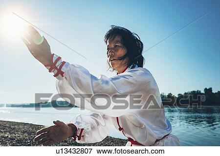 Women practicing tai chi by lake View Large Photo Image Stock Photo - Women practicing tai chi by lake. Fotosearch