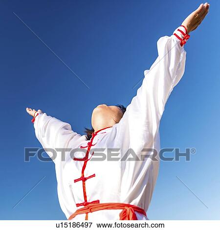 Stock Photo - Women practicing tai chi by lake. Fotosearch