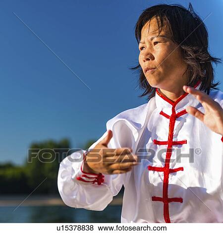Women practicing tai chi by lake View Large Photo Image Stock Photo - Women practicing tai chi by lake. Fotosearch