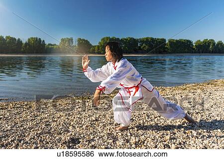 Women practicing tai chi by lake View Large Photo Image Stock Photograph - Women practicing tai chi by lake. Fotosearch