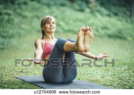 Yoga boat pose View Large Photo Image Stock Photograph - Yoga boat pose. Fotosearch