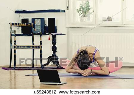 Stock Image - Yoga cobbler pose. Fotosearch