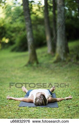Stock Photograph - Yoga corpse pose. Fotosearch