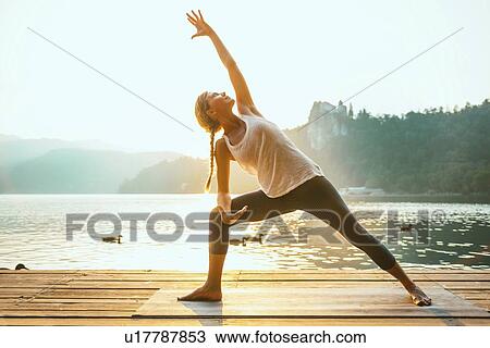 Yoga extended triangle pose View Large Photo Image Stock Image - Yoga extended triangle pose. Fotosearch