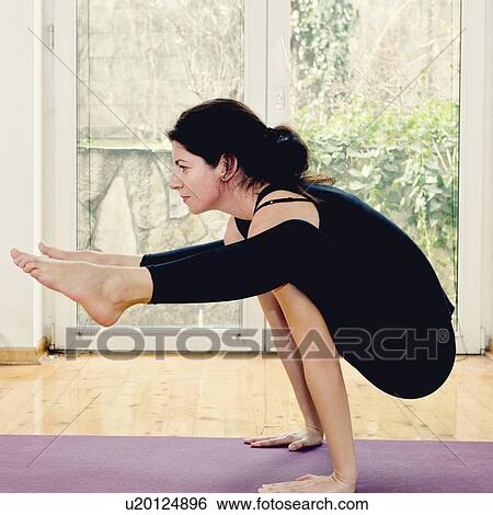 Stock Photograph - Yoga firefly position. Fotosearch