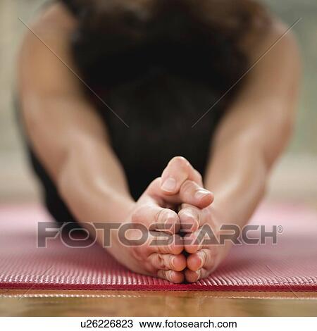 Stock Image - Yoga half tortoise pose. Fotosearch