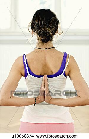 Picture - Yoga reverse prayer position. Fotosearch