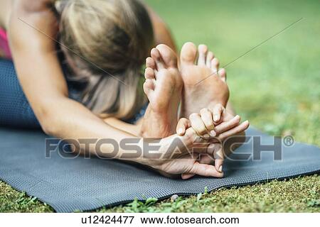 Yoga seated forward bend View Large Photo Image Stock Photo - Yoga seated forward bend. Fotosearch