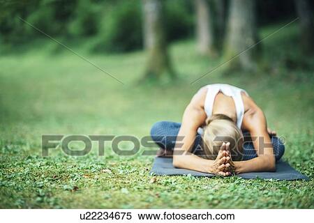 Stock Photography - Yoga seated forward bend. Fotosearch