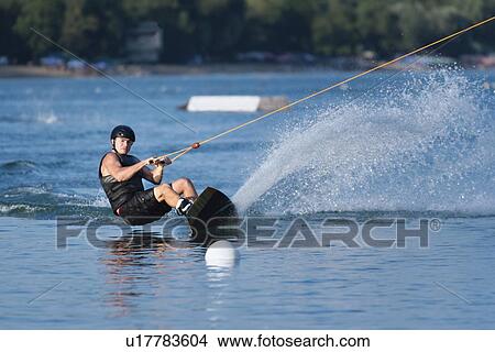 Picture - Young man wakeboarding. Fotosearch