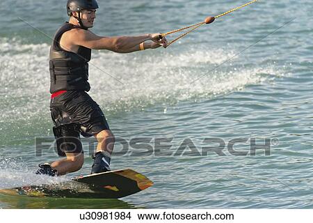 Young man wakeboarding View Large Photo Image Picture - Young man wakeboarding. Fotosearch