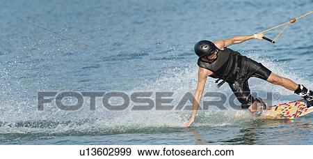 Stock Photo - Young man wakeboarding. Fotosearch