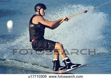 Young man wakeboarding View Large Photo Image Stock Photo - Young man wakeboarding. Fotosearch