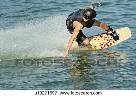 Young man wakeboarding View Large Photo Image Stock Photo - Young man wakeboarding. Fotosearch