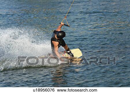 Young man wakeboarding View Large Photo Image Stock Photograph - Young man wakeboarding. Fotosearch