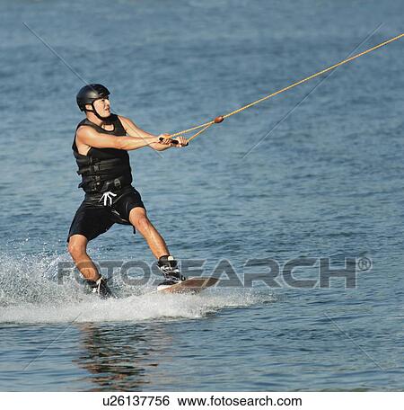 Stock Photograph - Young man wakeboarding. Fotosearch