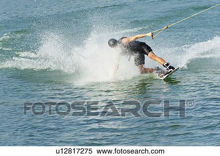 Young man wakeboarding View Large Photo Image Stock Photography - Young man wakeboarding. Fotosearch
