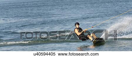 Stock Photography - Young man wakeboarding. Fotosearch