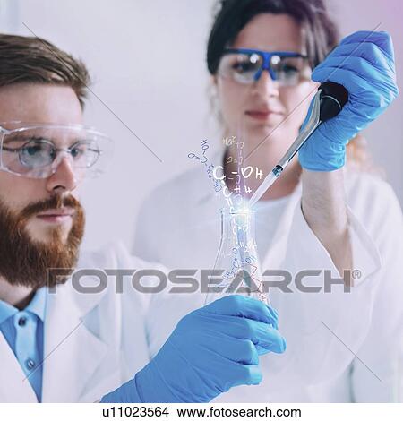 Picture - Young scientists working in laboratory. Fotosearch