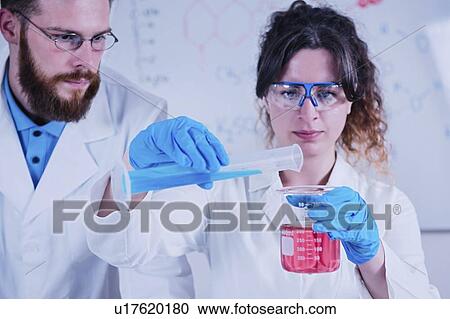 Stock Image - Young scientists working in laboratory. Fotosearch