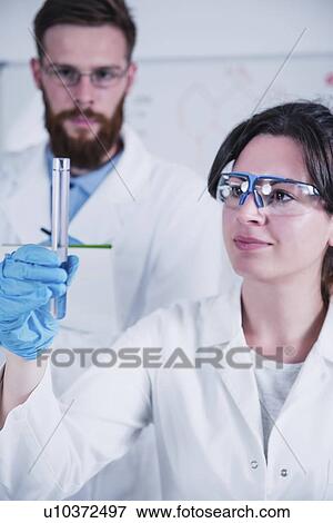 Stock Photo - Young scientists working in laboratory. Fotosearch